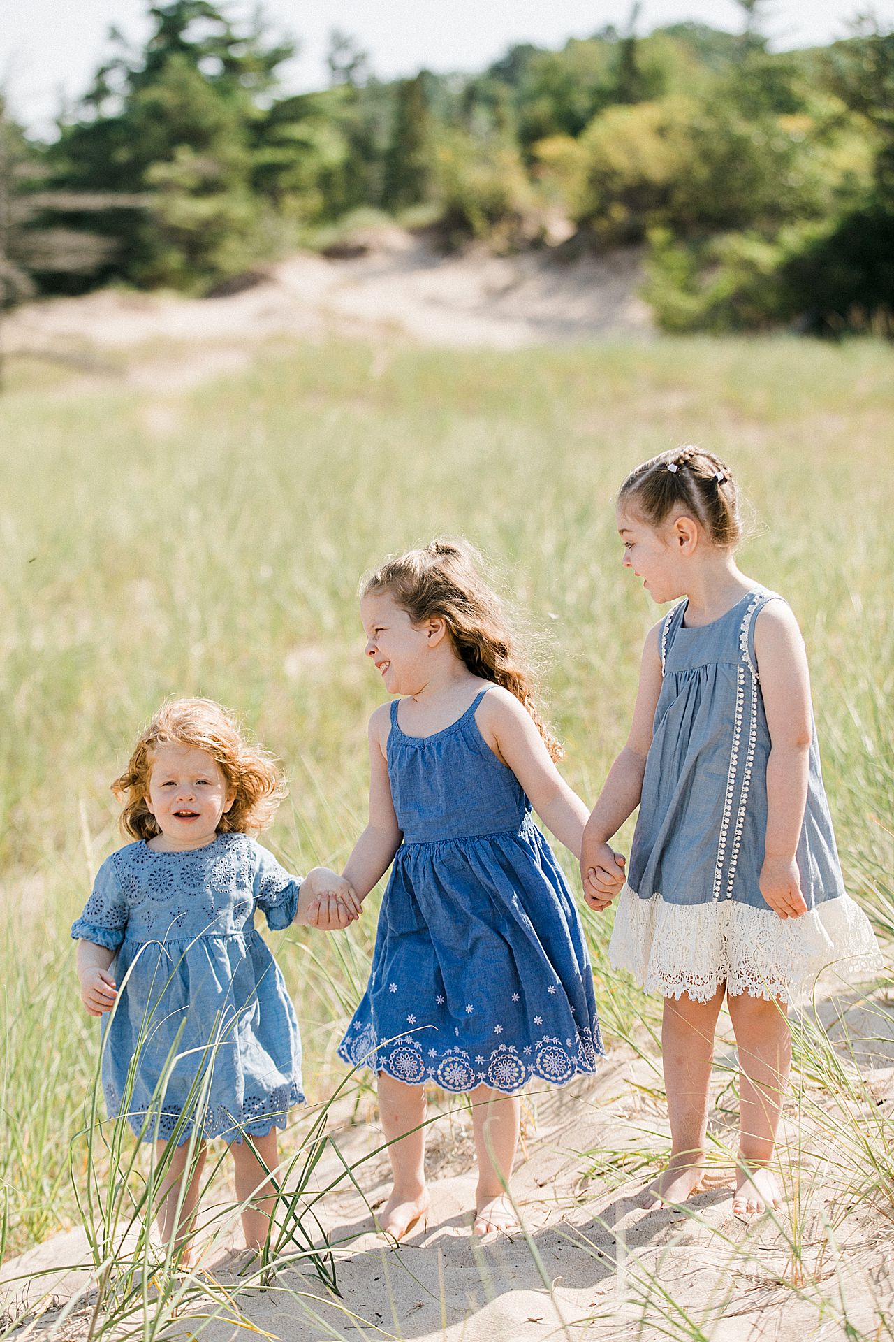 Three young girls laughing and smiling together