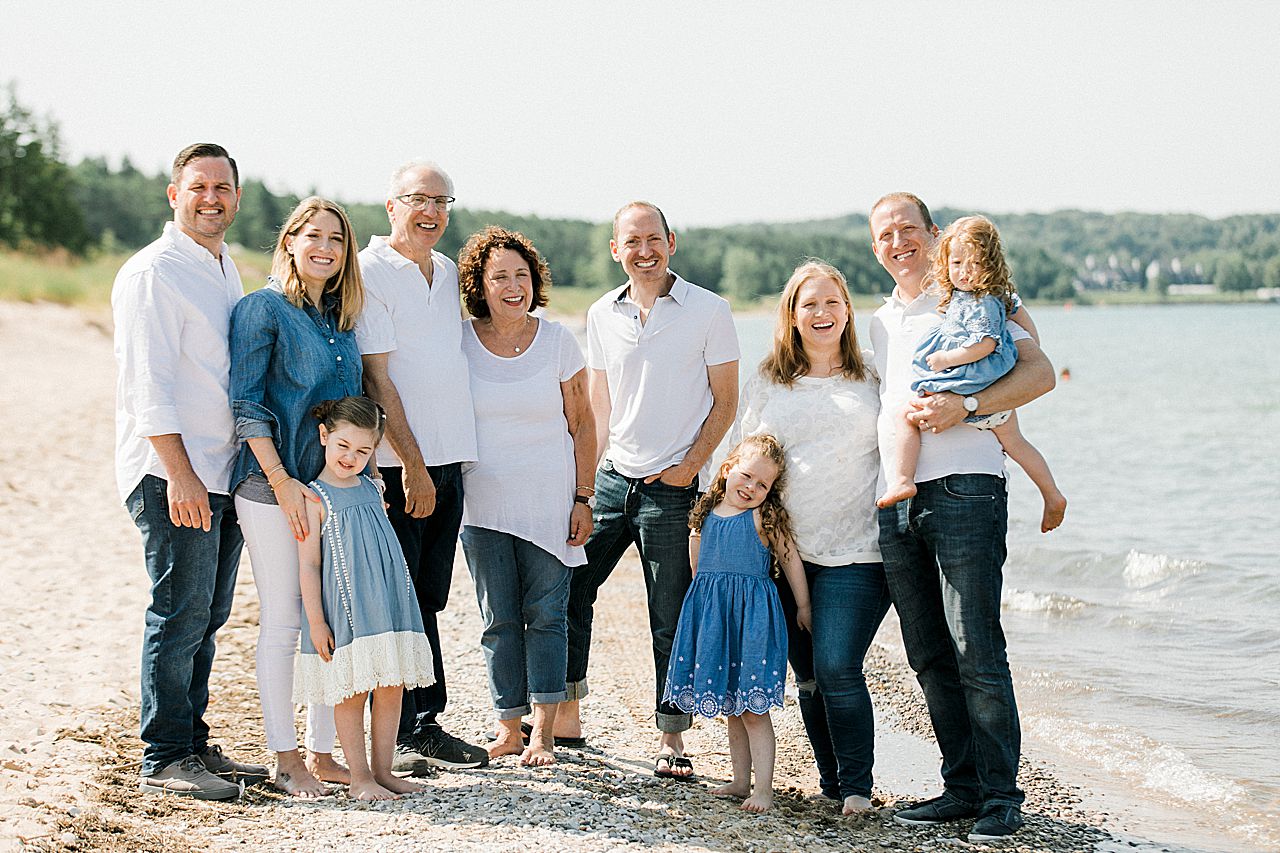 Whole family posing on a beach in Northern Michigan