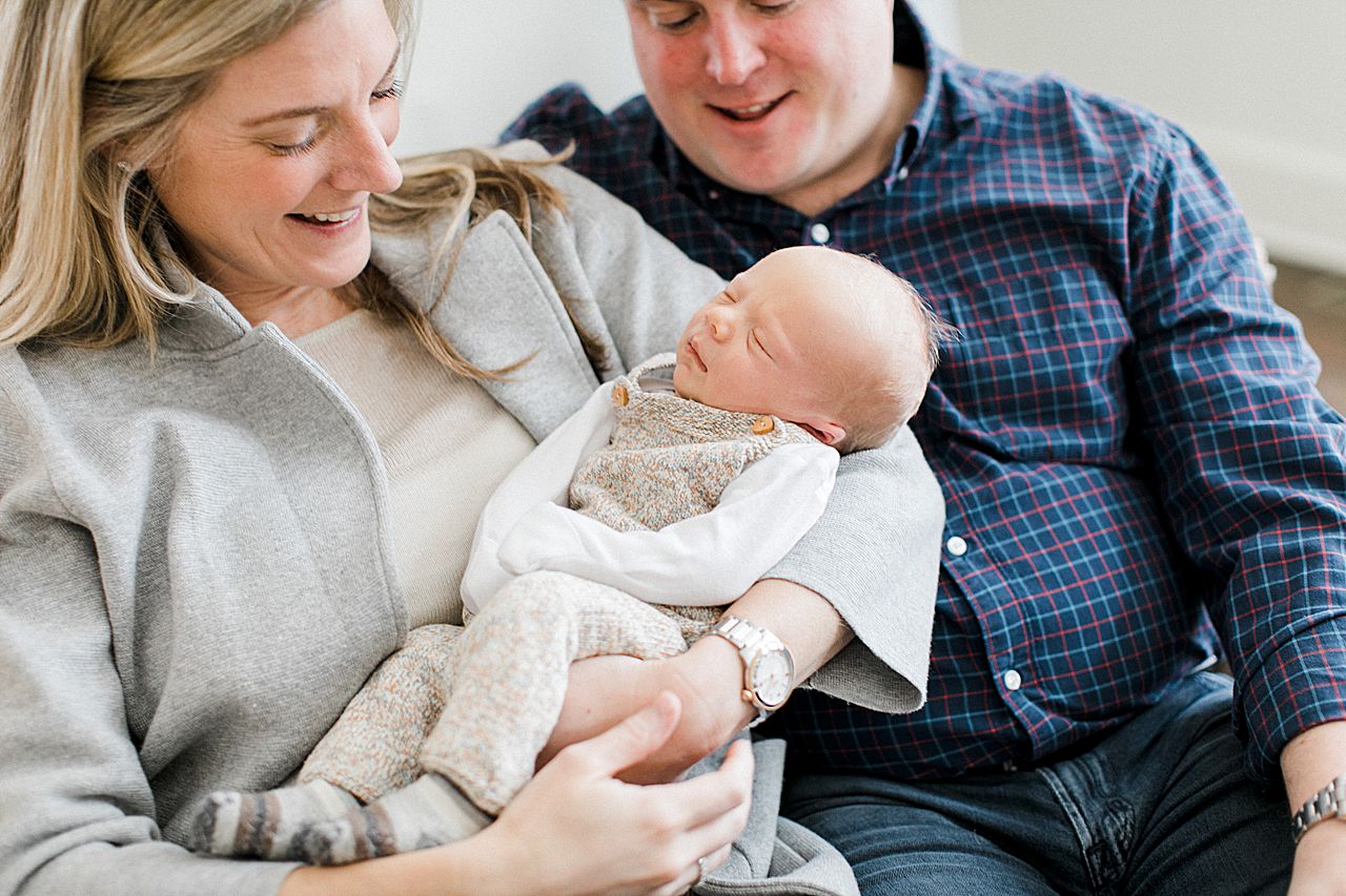 New parents smiling at their newborn