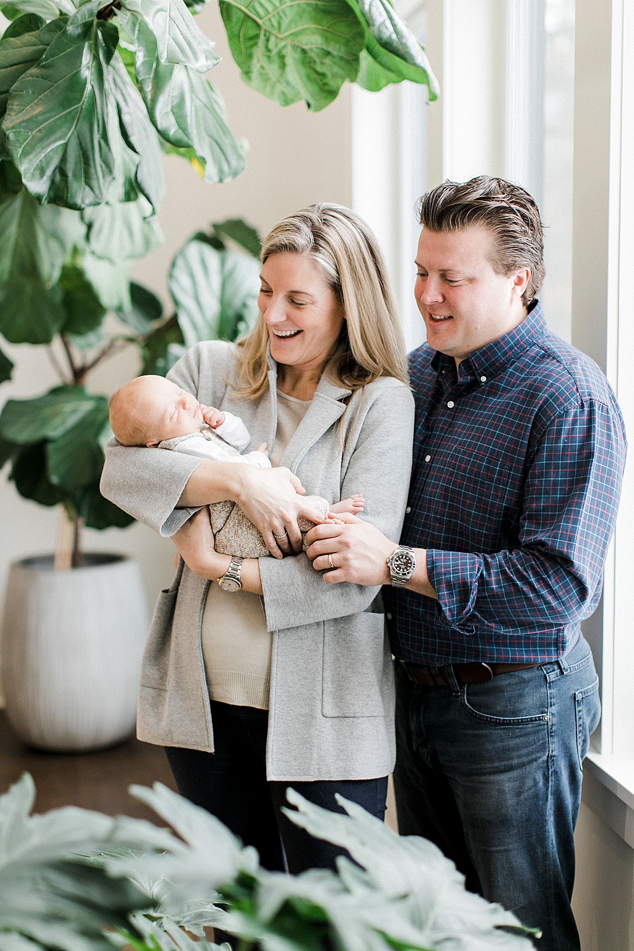 New mom and dad admiring their newborn at their home in Michigan