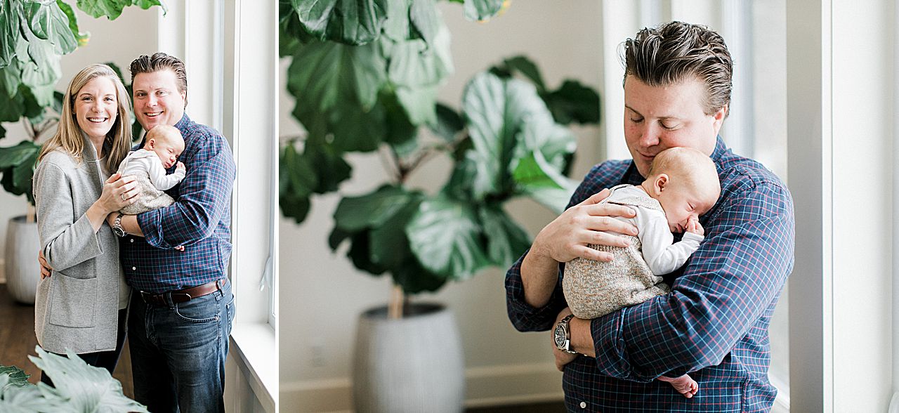 Father gently holding his newborn baby