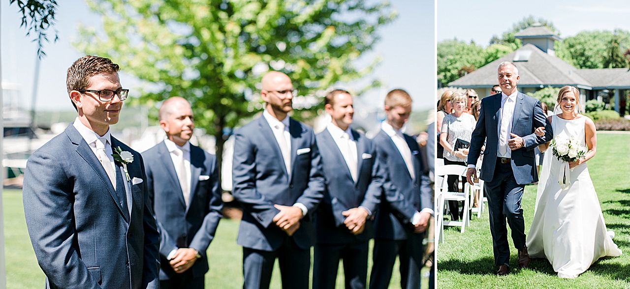 Groom standing under arch watching the bride walk down the aisle