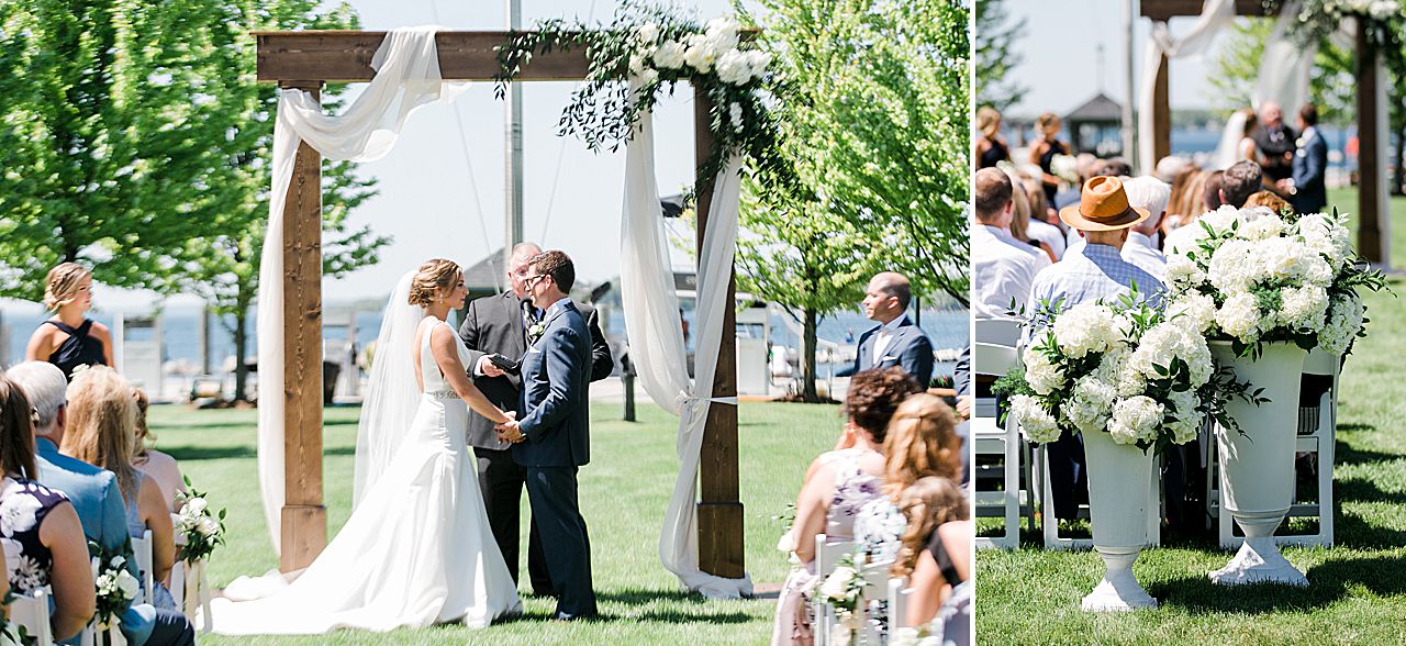 Bride and groom under an arch at their wedding ceremony with Lake Charlevoix in the background in Boyne City, Michigan