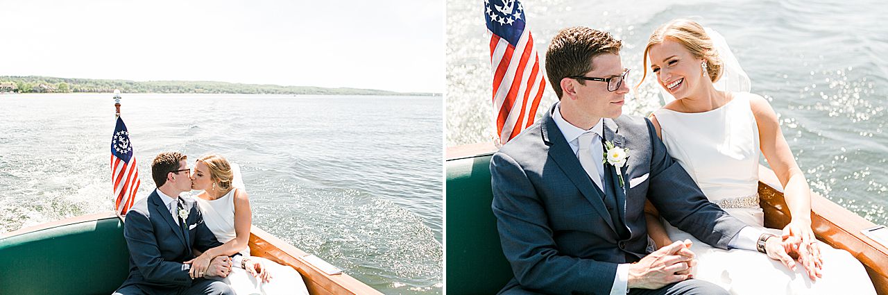 Bride and groom kissing in a Chris Craft boat on Lake Charlevoix on a sunny day