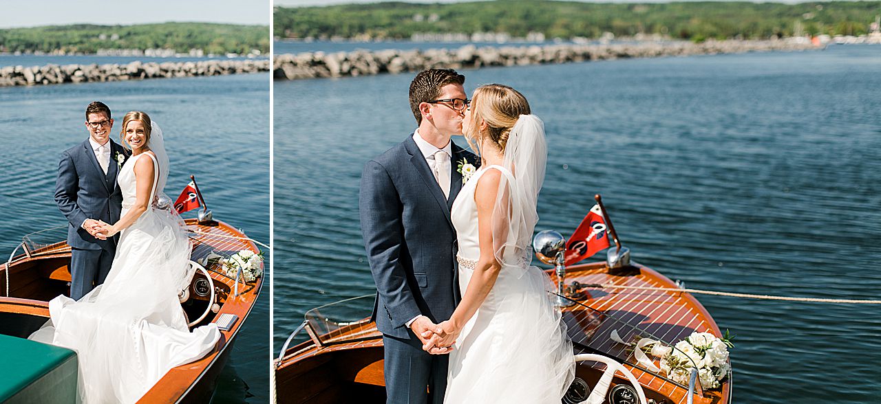 Bride and groom standing on a boat in The Harborage Marina in Boyne City, Michigan on a sunny day