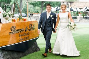 Bride and groom walking into their wedding reception at Boyne Mountain Resort on Deer Lake