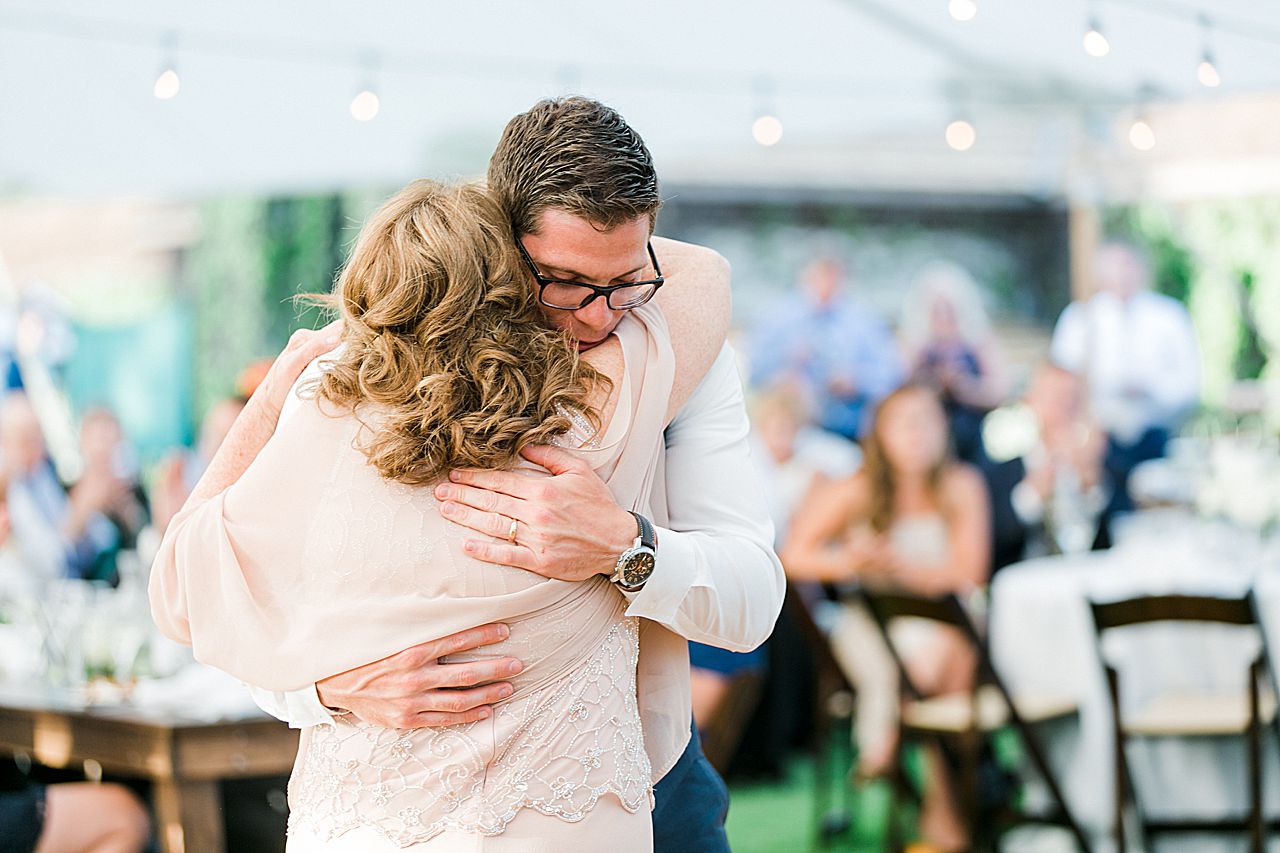 Groom and mother of the groom hugging after dancing at a wedding reception at Boyne Mountain Resort
