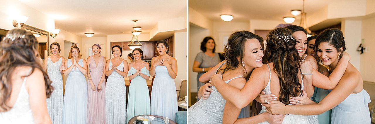 A bride showing the bridesmaids her final look and hugging them