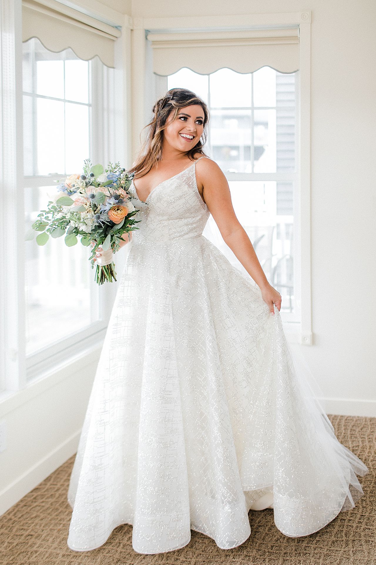 A bride holding her bouquet and the skirt of her wedding dress
