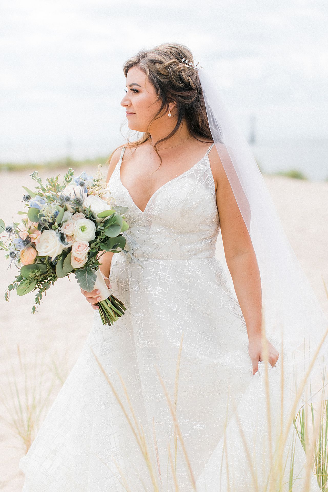 A bride on the beach by Lake Michigan in Frankfort, Michigan
