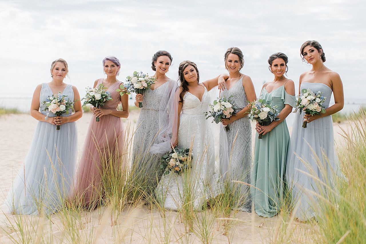 A bride with her bridesmaids on the beach in Frankfort, Michigan