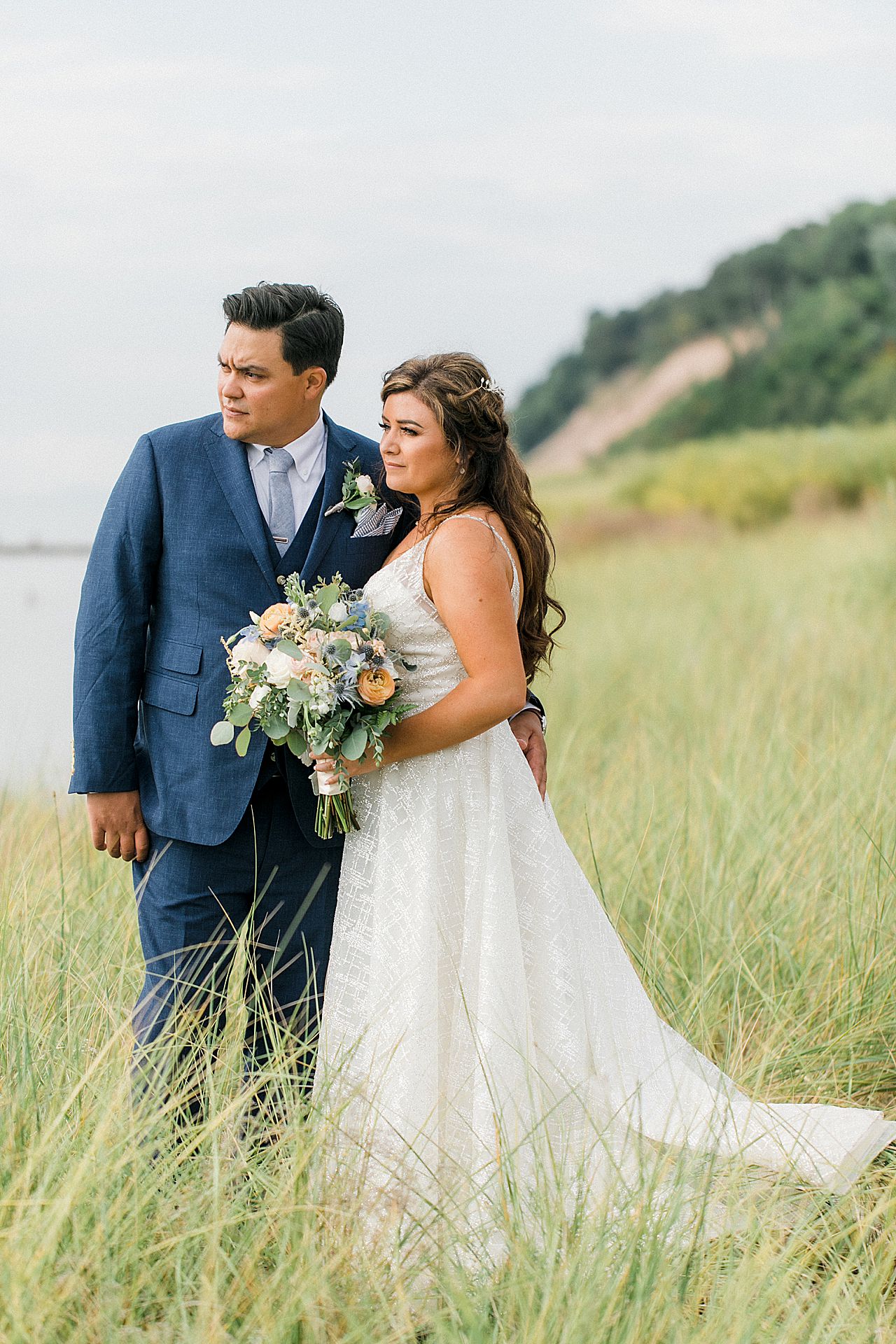 A bride and groom on the beach along Lake Michigan in Frankfort, Michigan