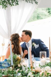 A bride and groom kissing at their wedding reception at the Elberta Life Saving Station