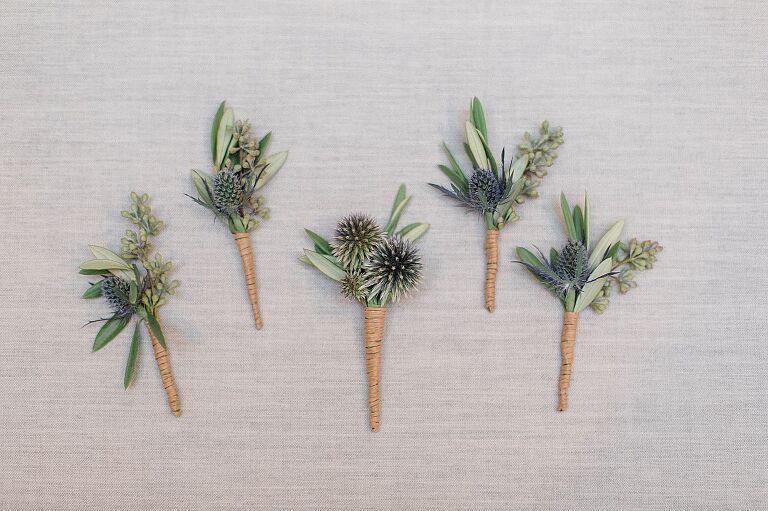Wedding boutonniere with green, blue, and twine