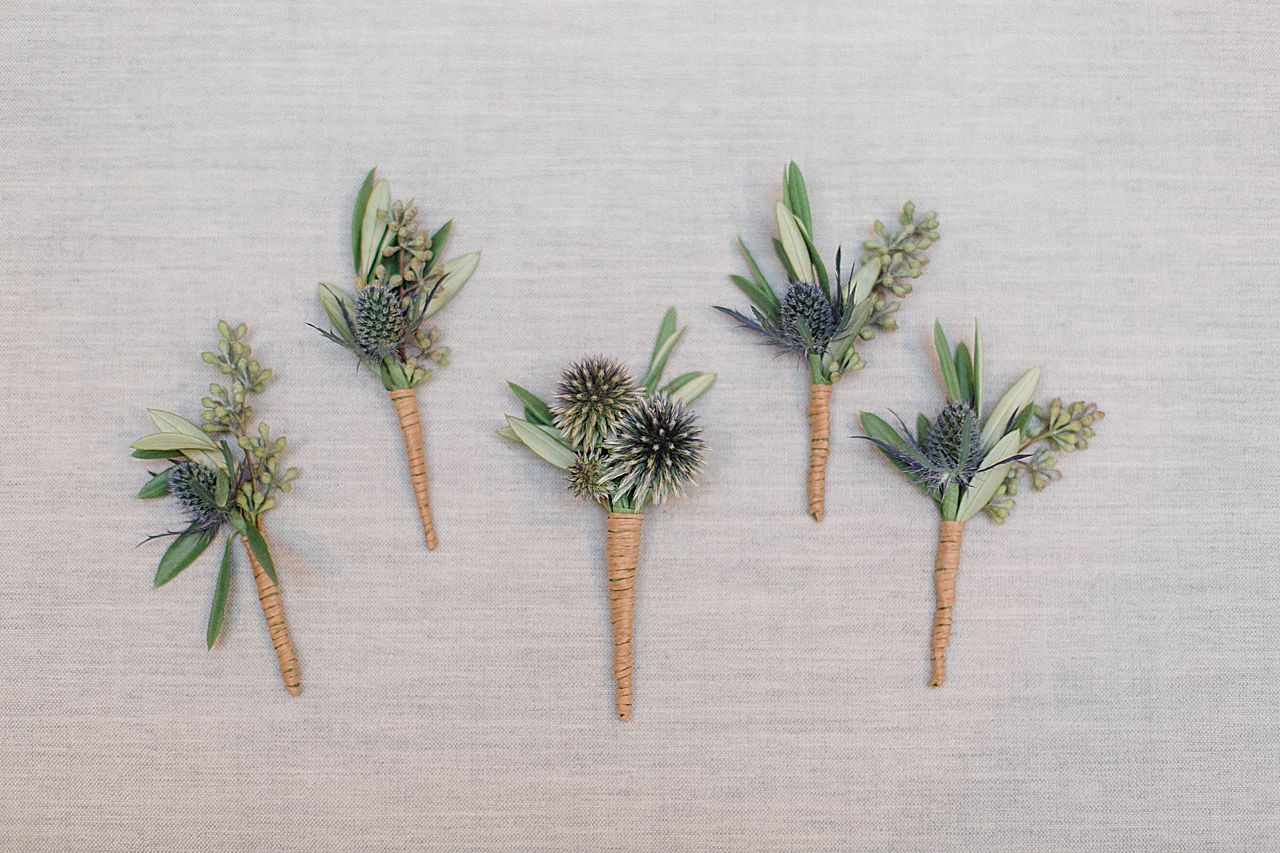 Wedding boutonniere with green, blue, and twine