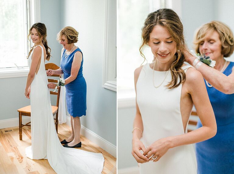 A bride getting her wedding dress on with help from her mother