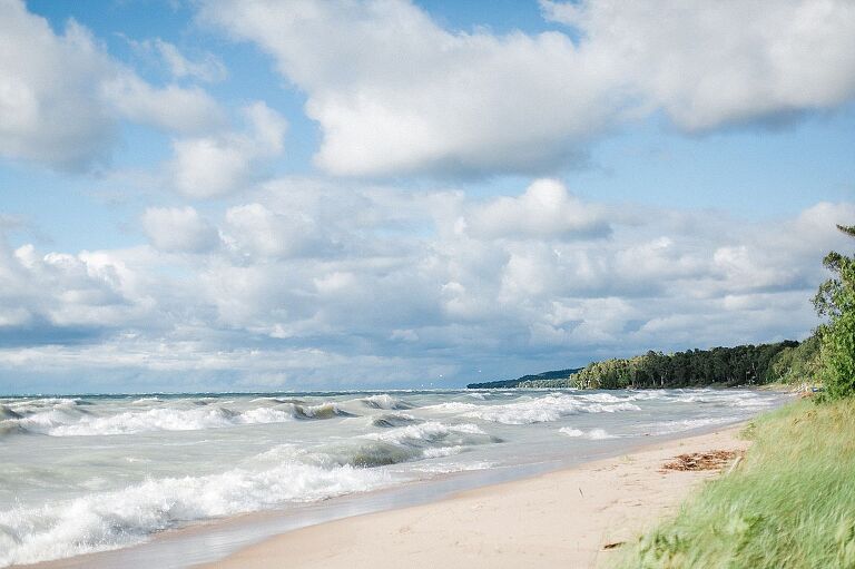 Lake Michigan on a sunny day with blue skies and large waves in Northport, Michigan