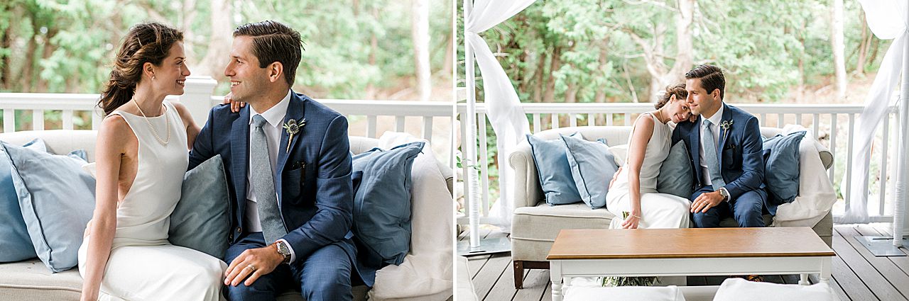 A bride and groom on a porch sitting on a couch at a private residence Northport, Michigan