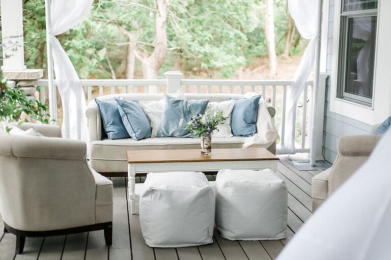 A tan linen couch arrangement on a porch at a private residence in Northport, Michigan