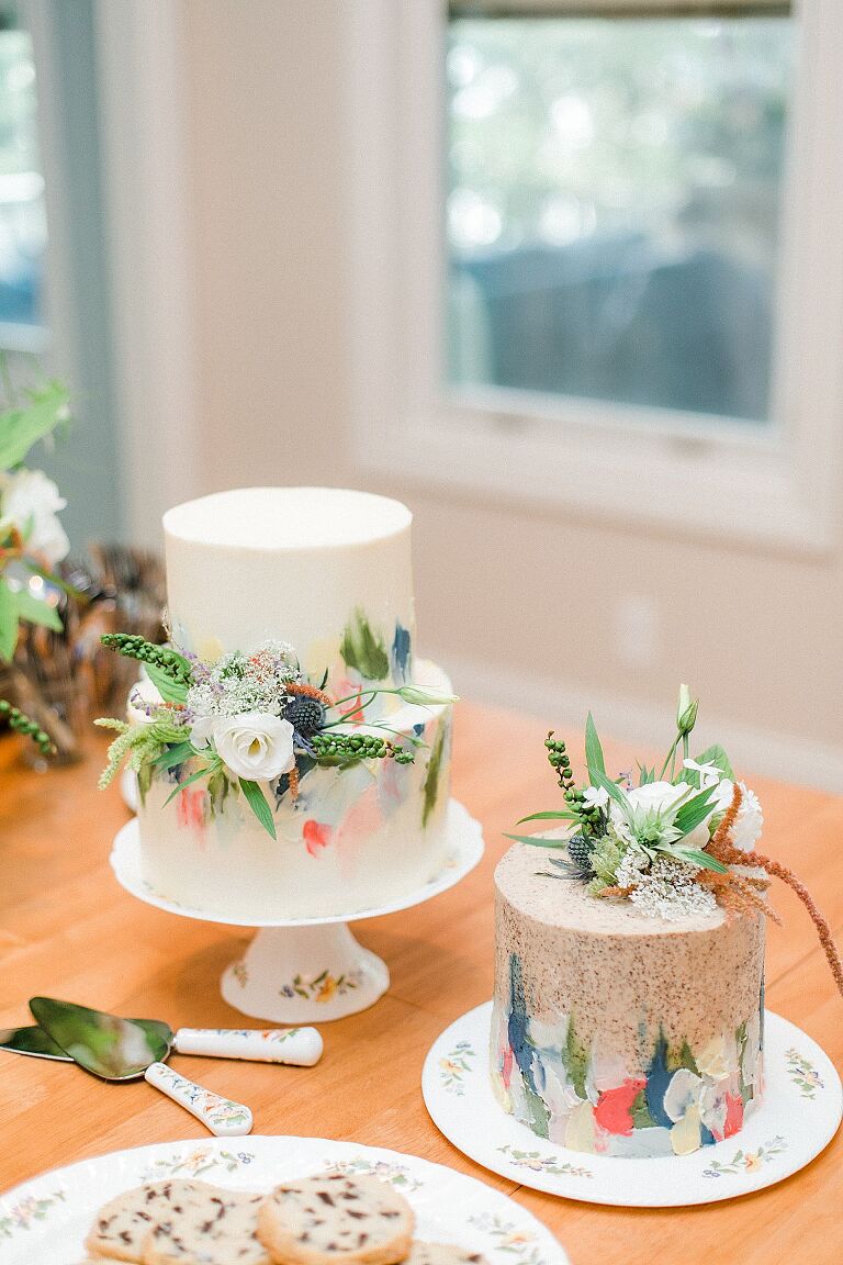 Two small wedding cakes with colorful watercolor designs