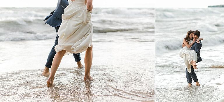 A bride and groom walking through the water along the lake in Northport, Michigan
