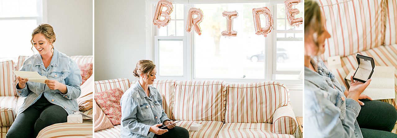 A bride opening a gift from her groom on her wedding day in Charlevoix, MI