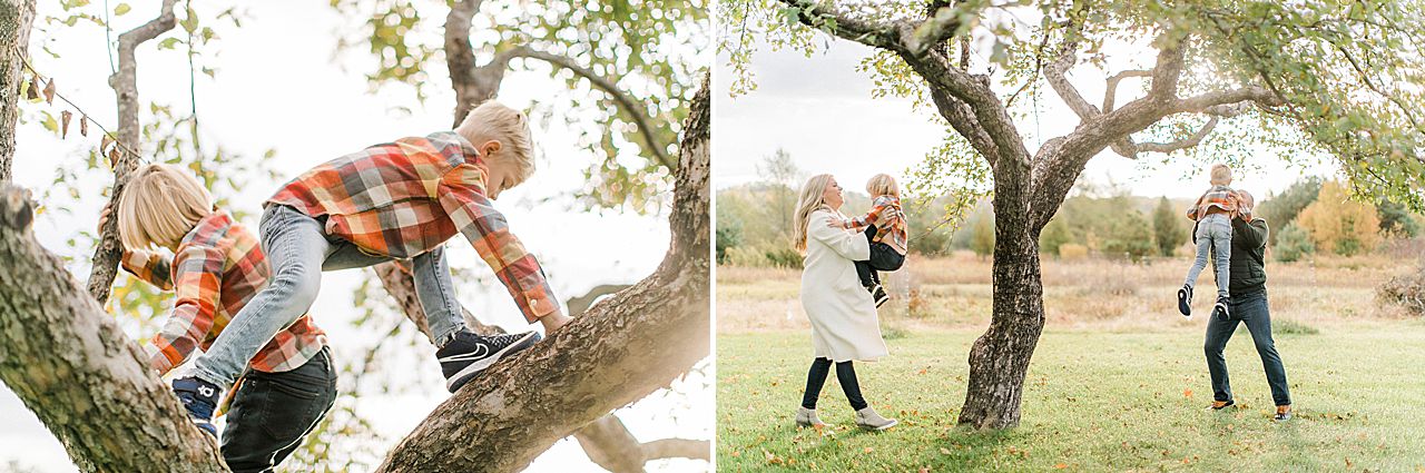 A mother and father playing with their children near a tree in Petoskey, Michigan