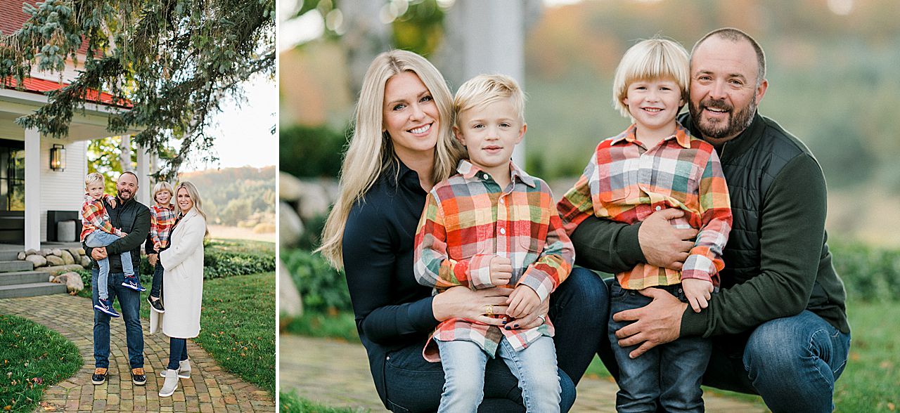 Family portrait of a mother, father, and their 2 boys in front of their farmhouse home in Petoskey, Michigan