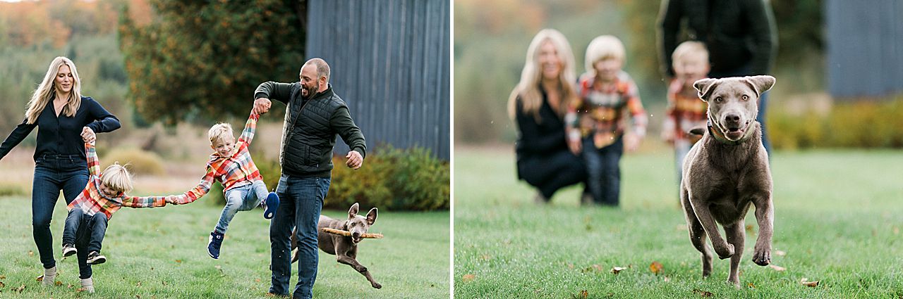 Family portrait of a family of 4 walking together while swinging their sons in the air in Northern Michigan