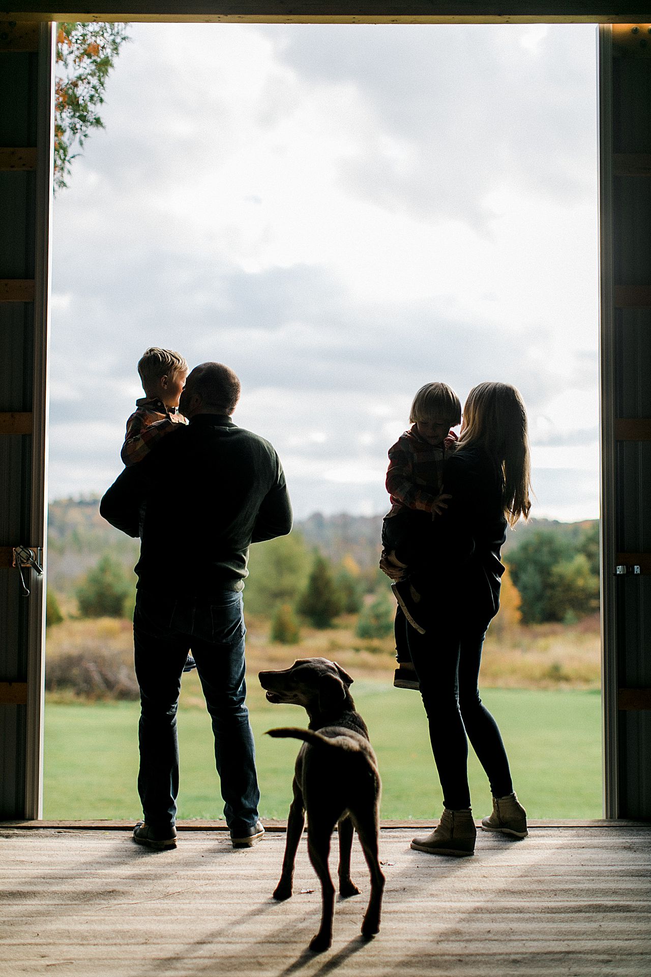 A silhouette of a family of 4 in a barn in Petoskey, Michigan