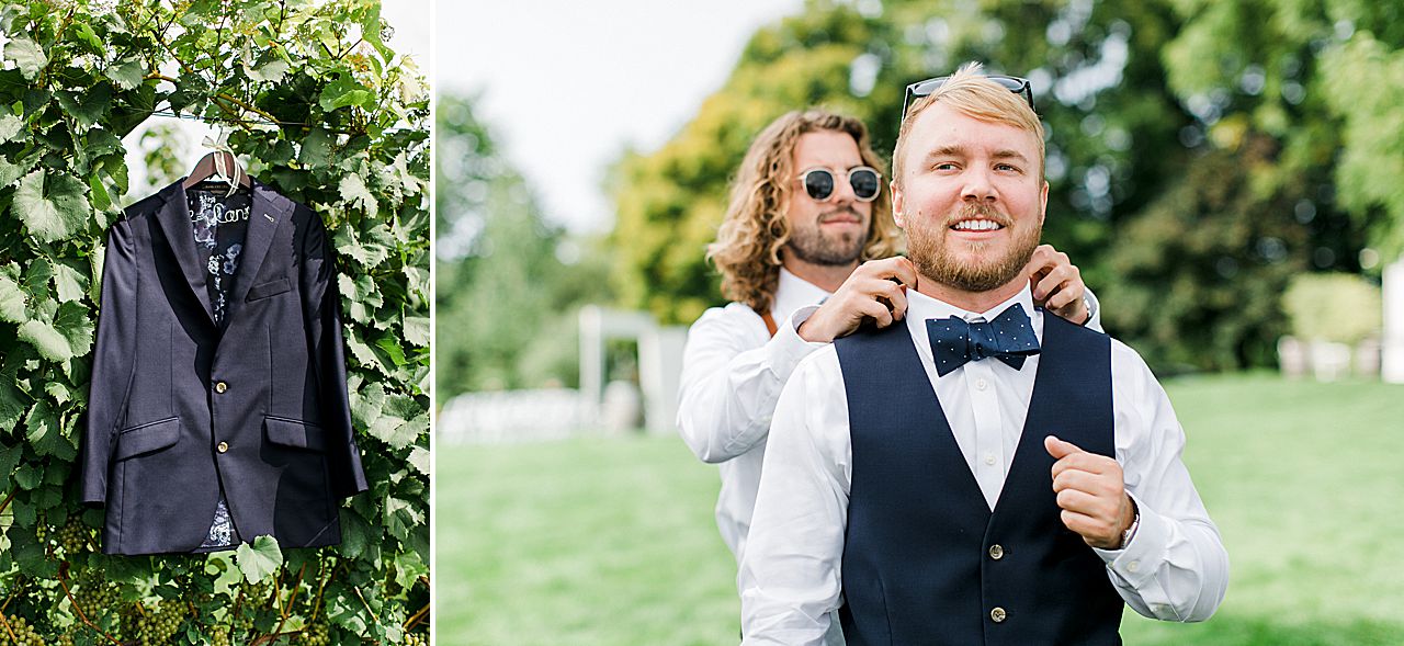 A groom getting dressed with the help of his groomsmen on his wedding day