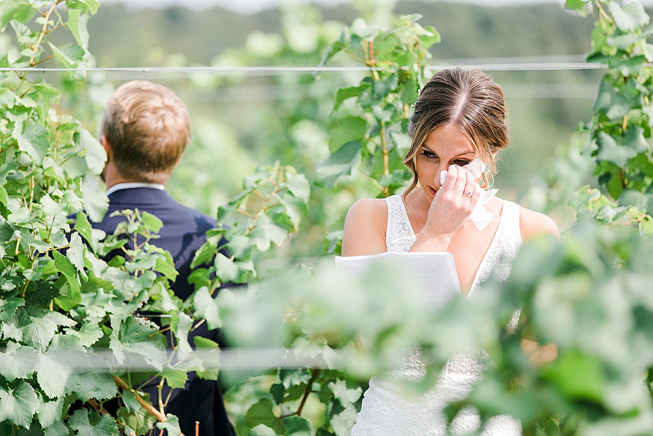 A bride and groom reading letters to each other at Aurora Cellars in the Leelanau Peninsula