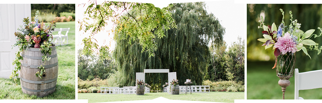 A wedding ceremony by a large willow tree at Aurora Cellars in Michigan