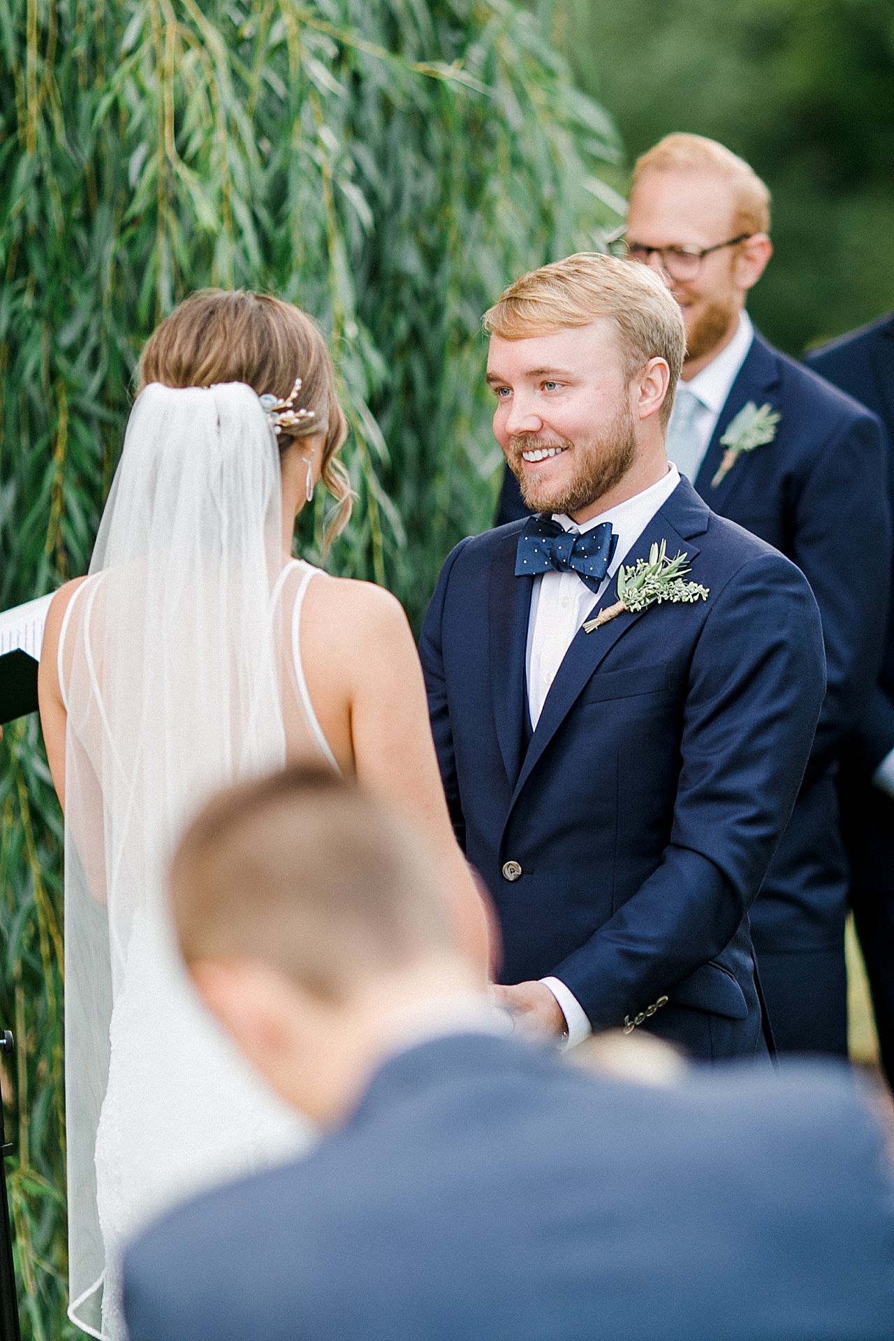A groom smiling at his bride on the Leelanau Peninsula