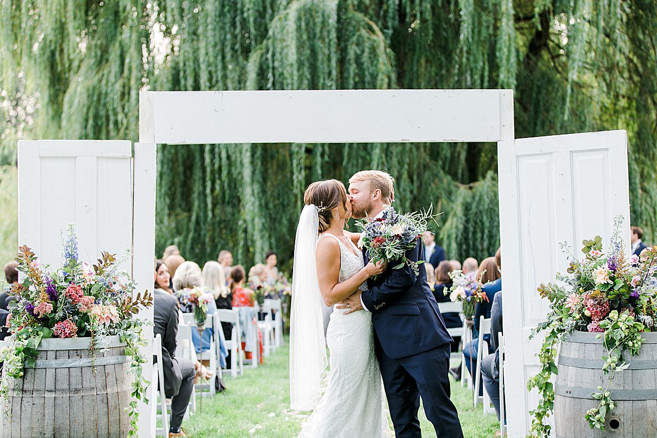 The bridegroom kissing at the end of the ceremony I'llThe bride and groom kissing at the end of the ceremony aisle