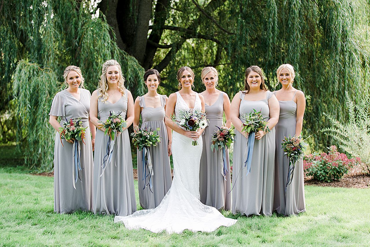 A bride and her bridesmaids under a willow tree in Northern Michigan