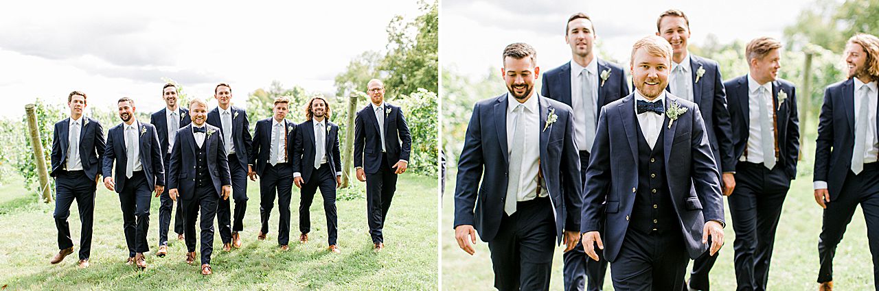 Groom and groomsman walking together near a Vineyard in Michigan