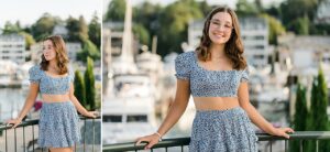 A girl wearing a blue crop top at the marina in downtown Charlevoix during her senior portrait session