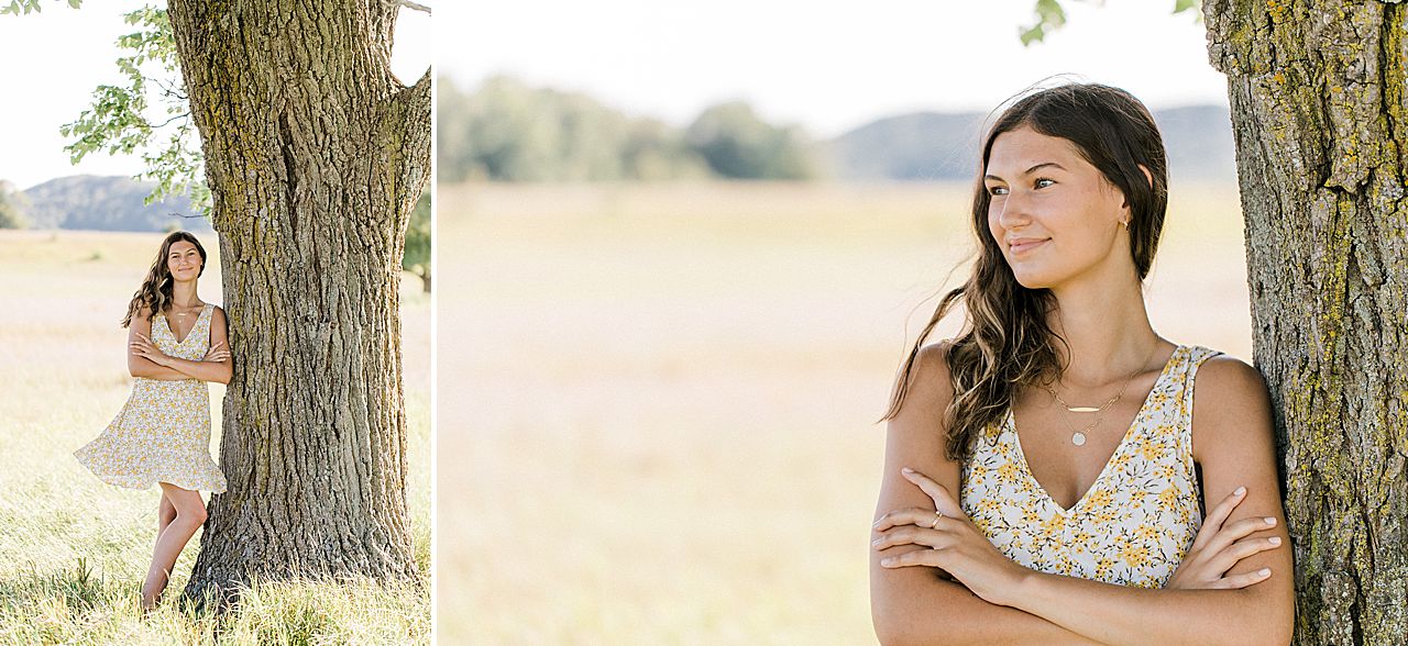 A girl leaning on a tree during her senior portrait session in Michigan