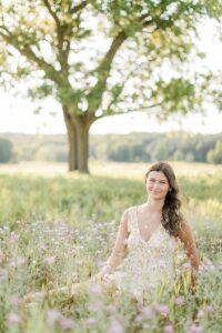 A girl on a sunny summer evening in Northern Michigan taking senior portraits