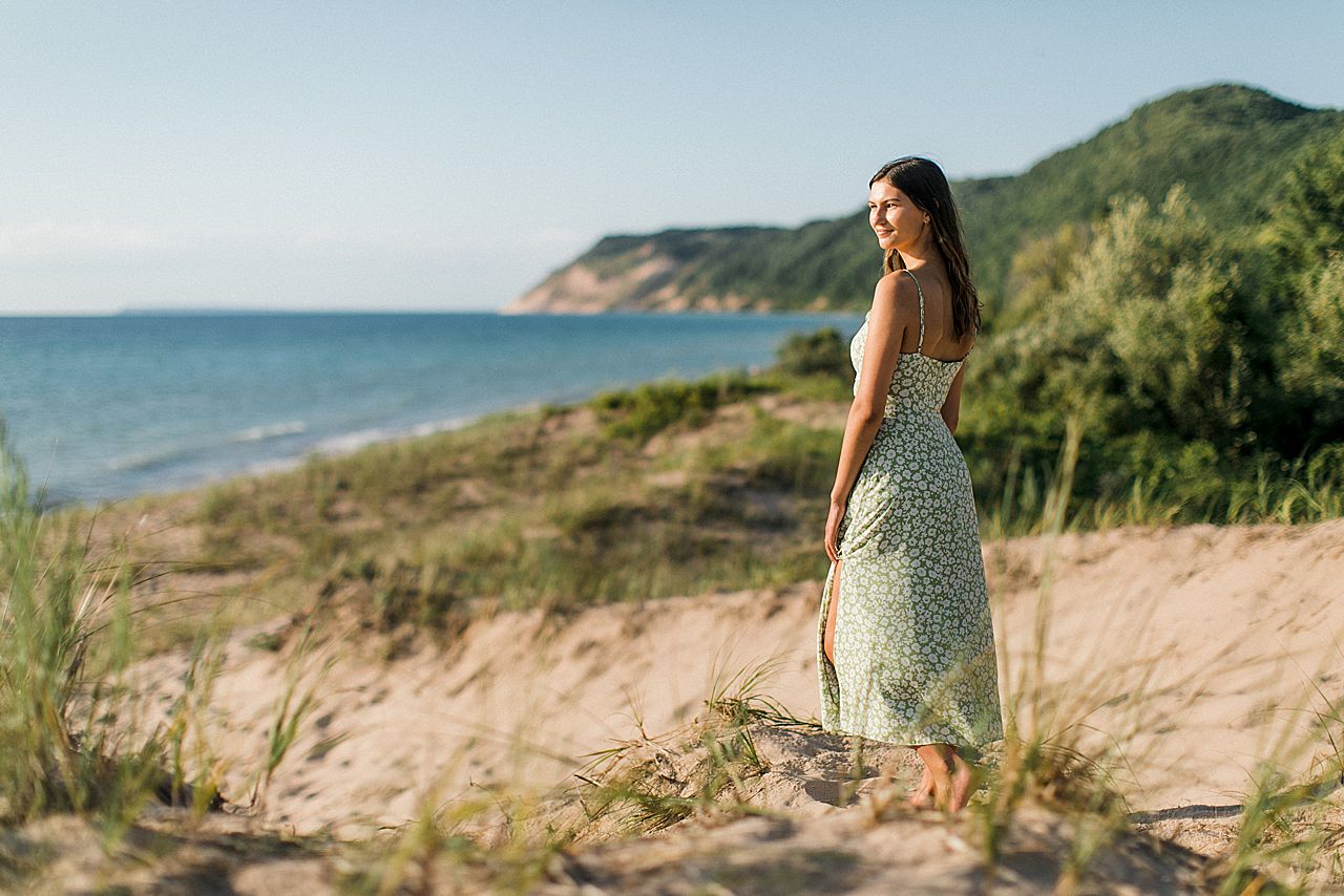 A girl standing on a sand dune at Sleeping Bear Dune National Lakeshore in Empire, Michigan