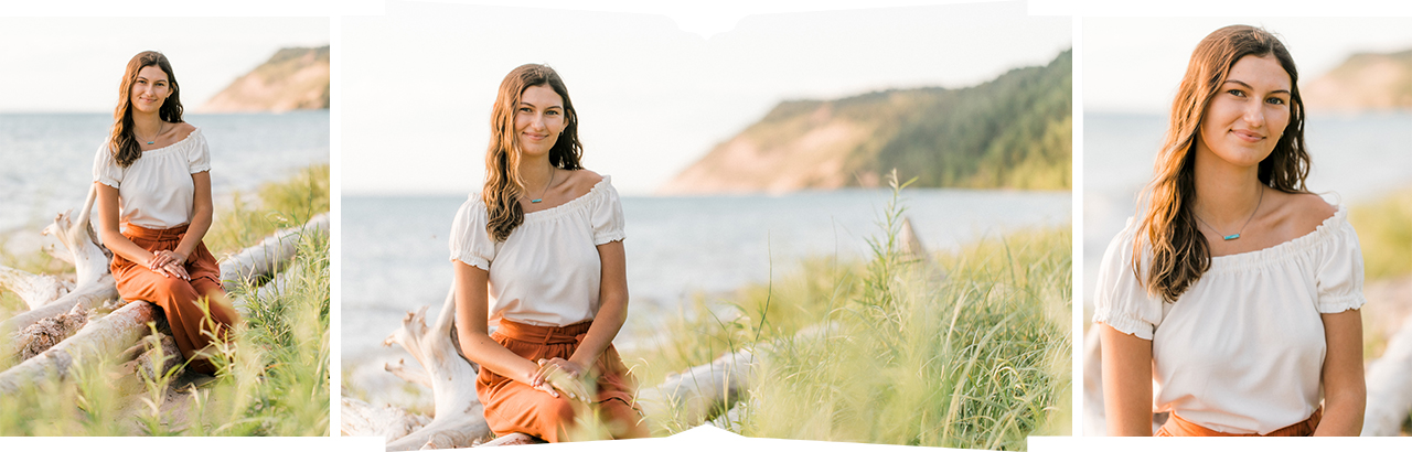 A girl sitting on logs near Lake Michigan during her senior portrait session at Sleeping Bear Dune National Lakeshore