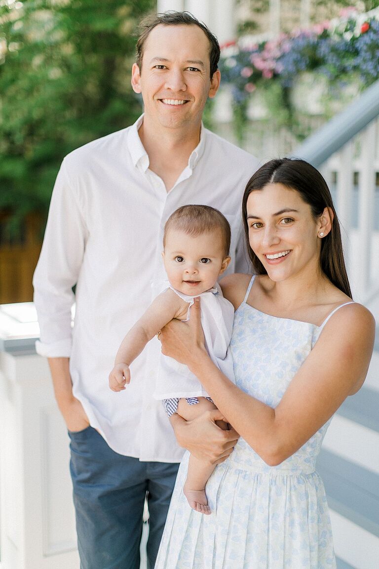 A mother, father, and baby on porch at Harbor Point in Harbor Springs, Michigan