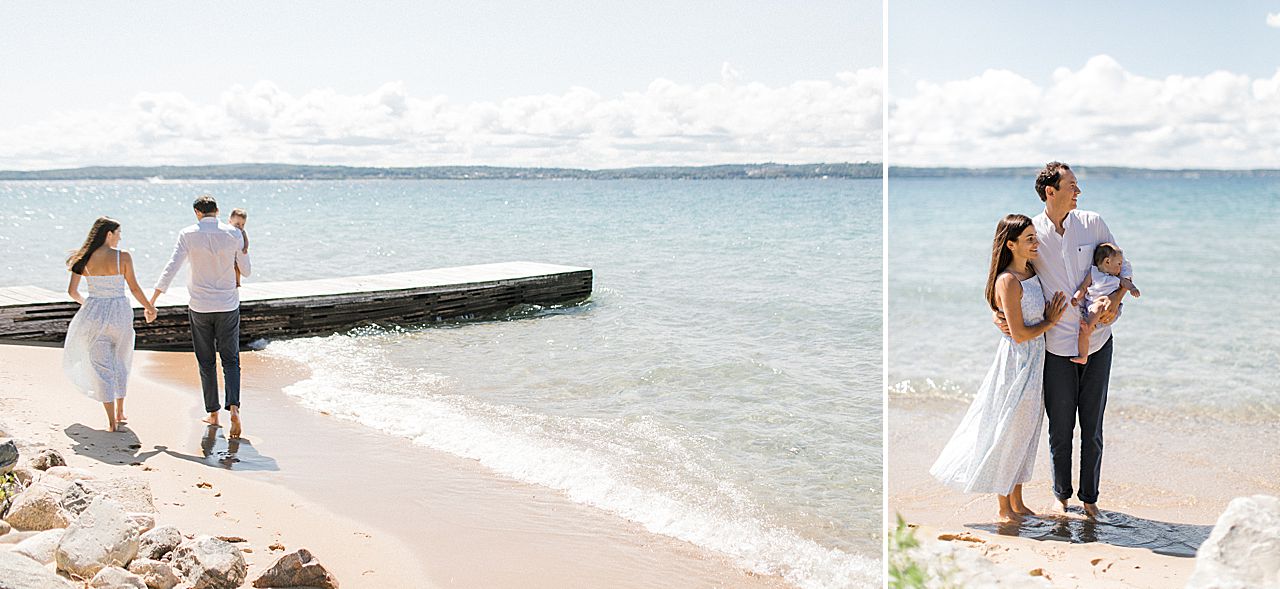 A family of three walking along the lakeshore in Northern Michigan on a sunny day