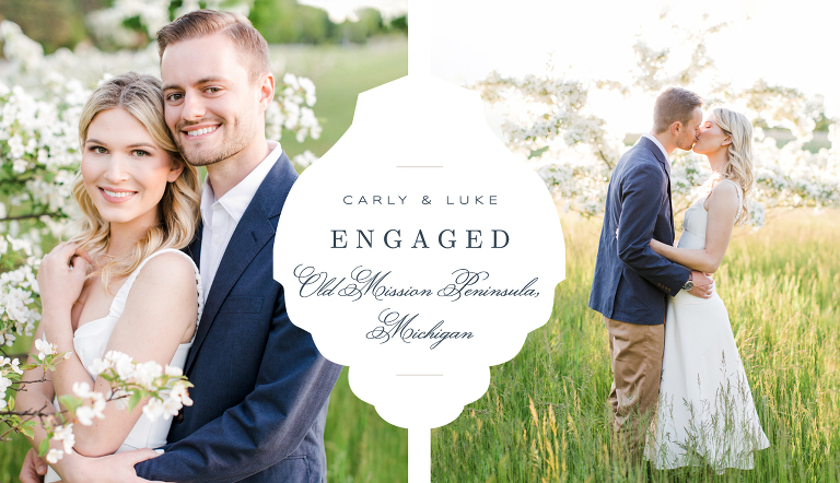 a couple taking engagement photos in a field with blooming trees in the spring