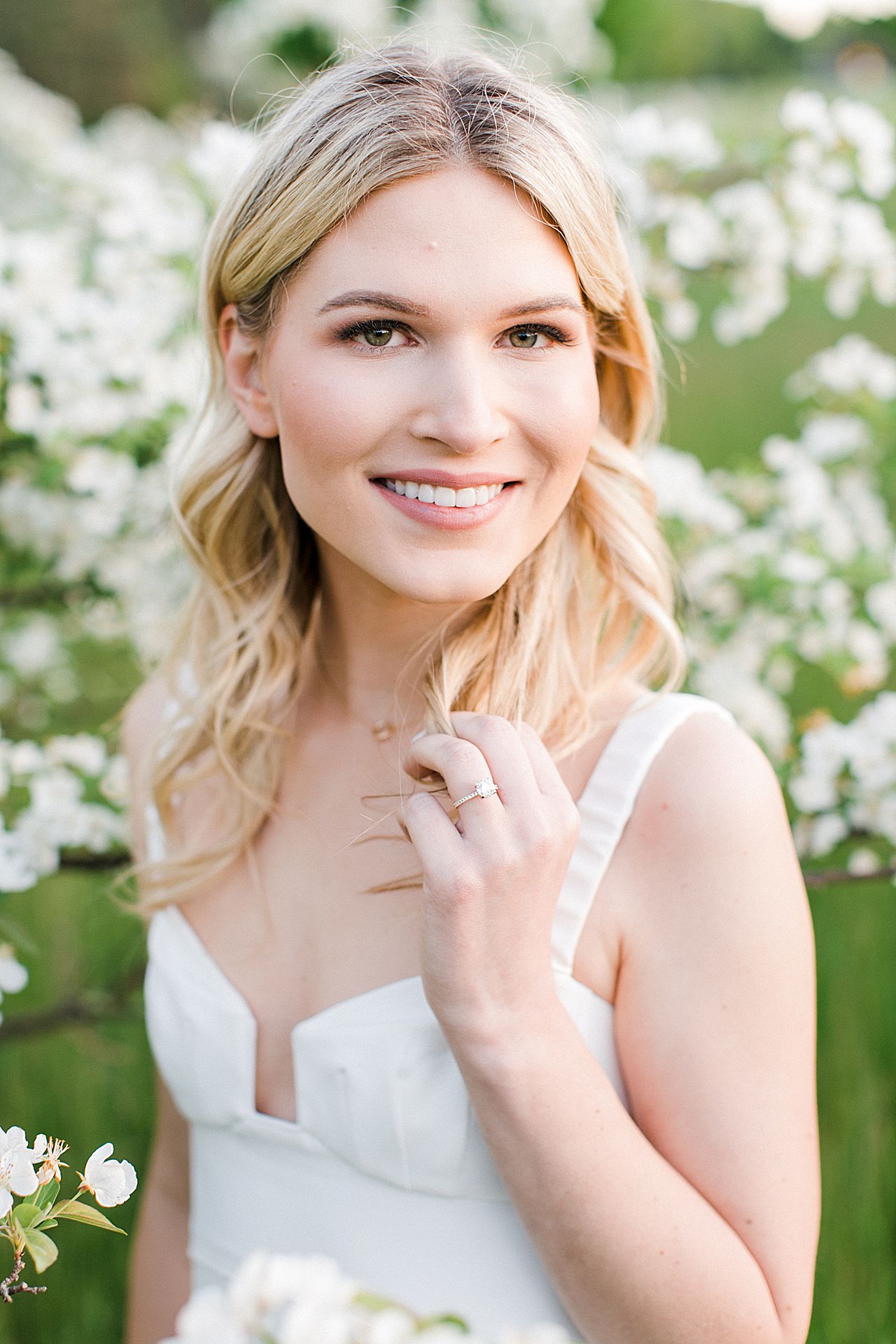Portraits of a fiancé woman near a blooming tree in the spring on Old Mission Peninsula