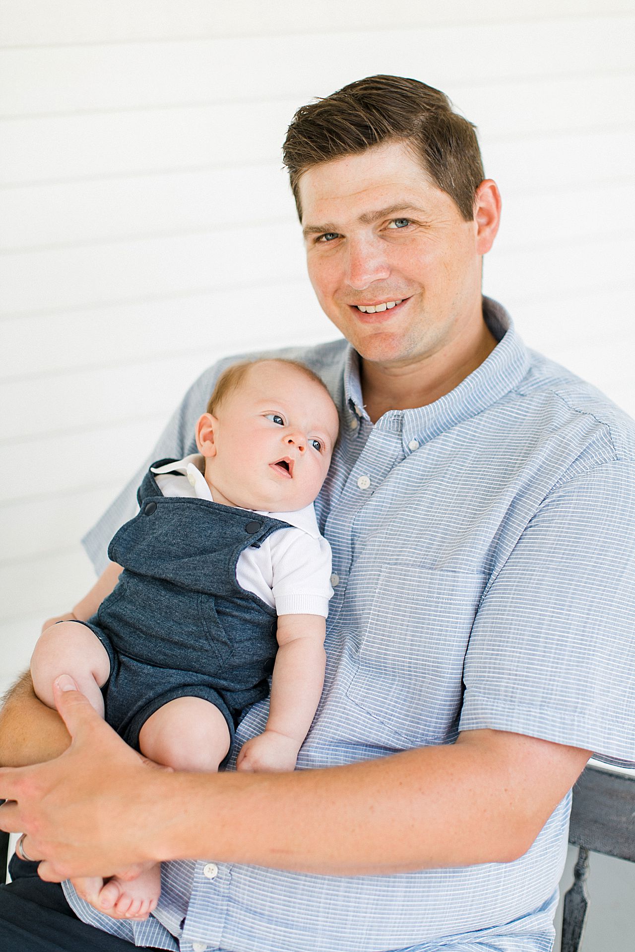 A portrait of a father and his newborn son in Petoskey, Michigan