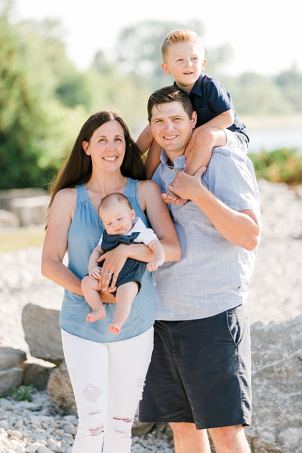 A portrait of a mother, father, and their 2 young sons in Michigan in the summer