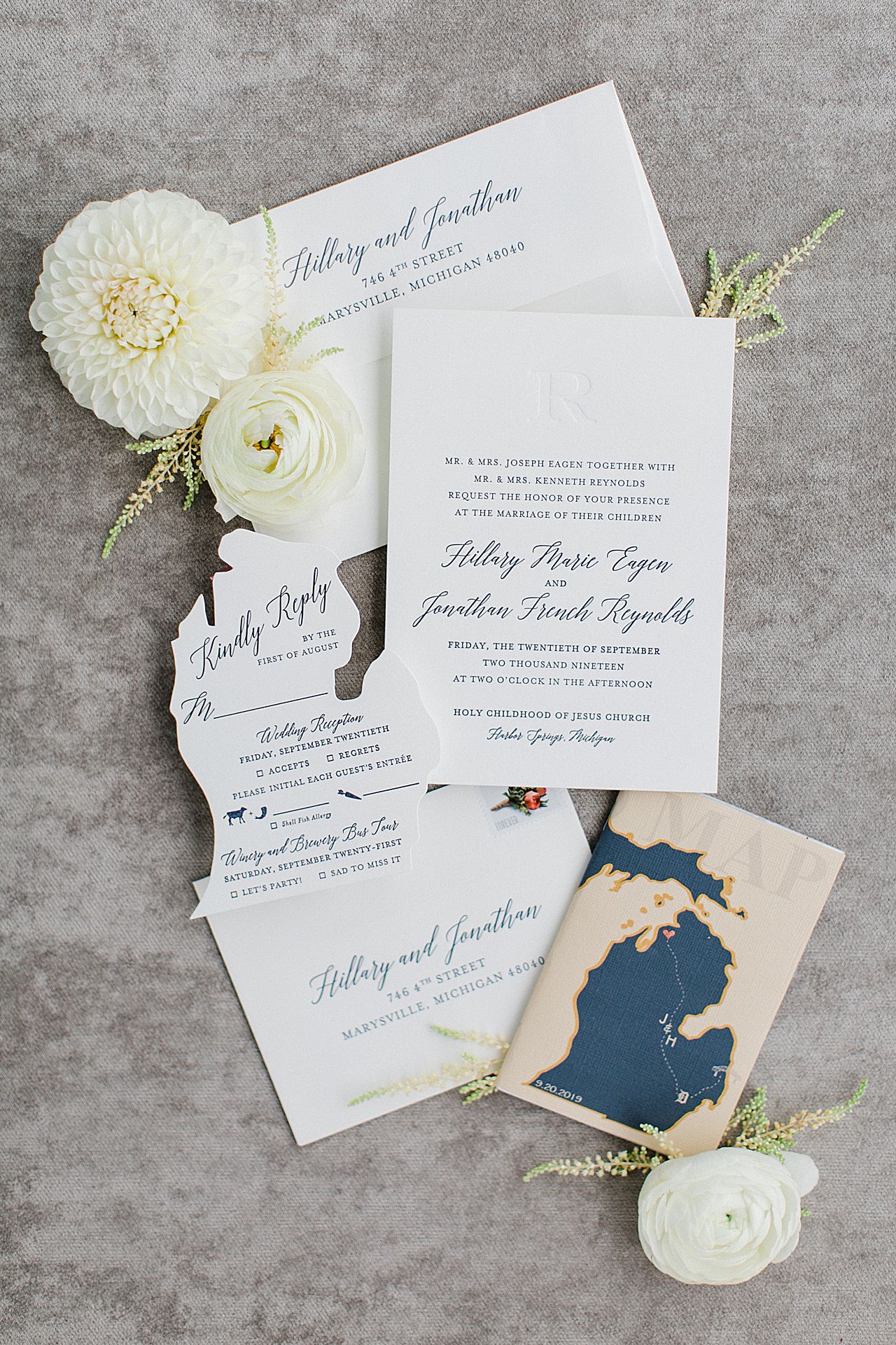 A wedding invitation suite with a Michigan cutout for the RSVP