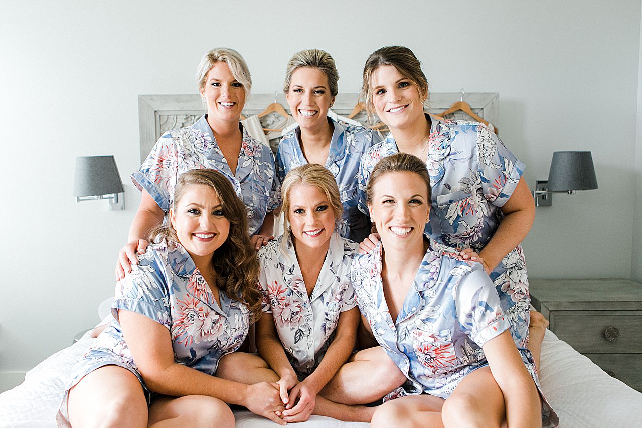 A bride in pajamas with her bridesmaids and mother in Bay Harbor, Michigan